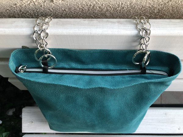 Top of waterproof green big fabric bag on bench