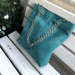 Side face of waterproof green big fabric bag on bench