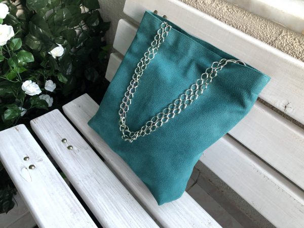 Side face of waterproof green big fabric bag on bench