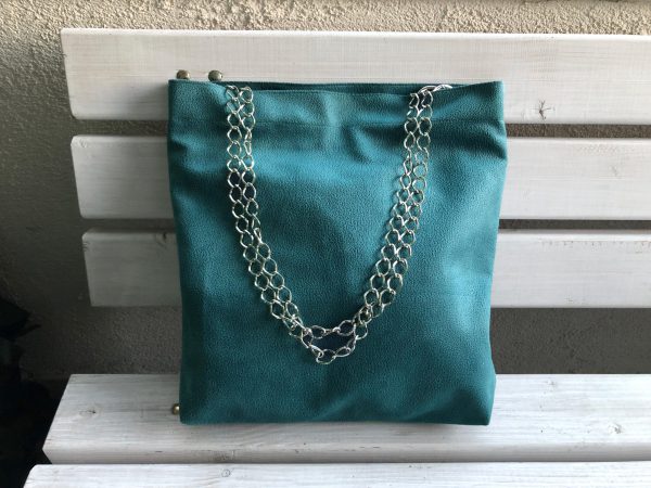 Front of waterproof green big fabric bag on bench