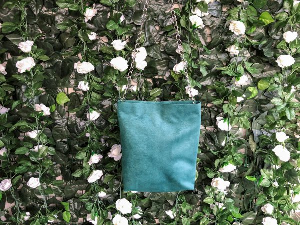 Front of green waterproof fabric bag on hanger