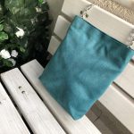 Green waterproof fabric bag on the bench