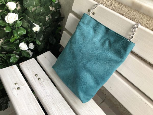 Green waterproof fabric bag on the bench