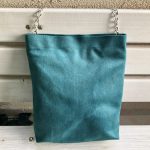 Front of green waterproof fabric bag on bench