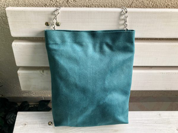 Front of green waterproof fabric bag on bench