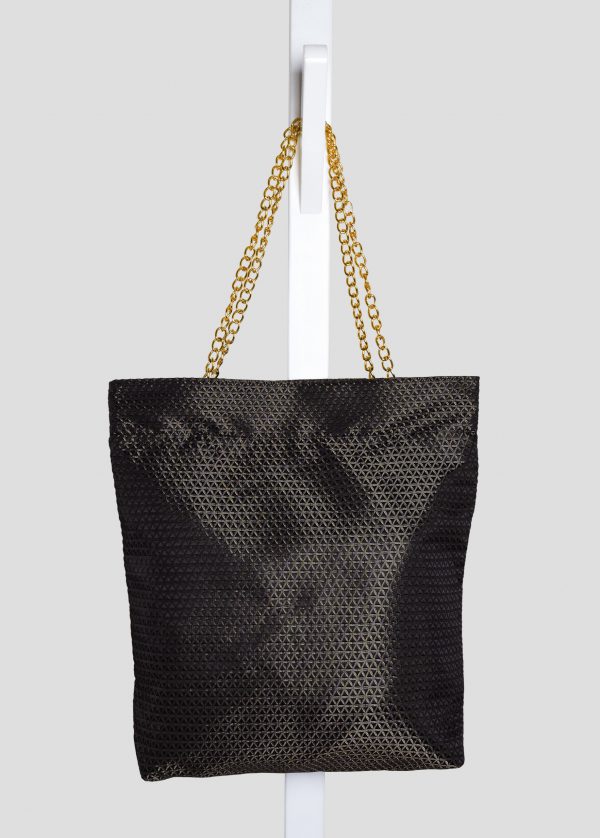 Indoor shoot of black triangle textured bag