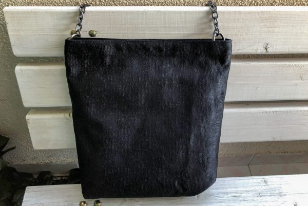 Front of black fabric bag on the bench