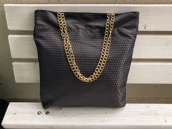 Front of the black triangle textured bag