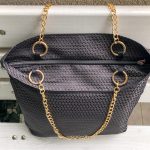 Top of the black triangle textured bag