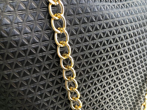 Hanger detail of the black triangle textured bag