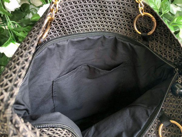 Interior detail of the black triangle textured bag