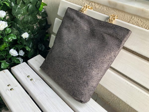 Side of beige color fabric bag on the bench