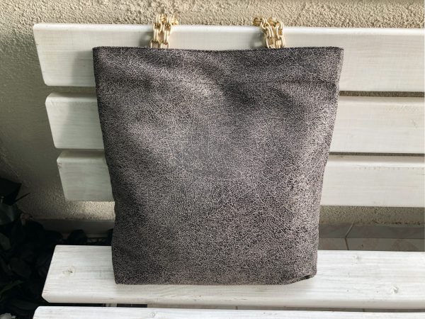 Front of beige color fabric bag on the bench