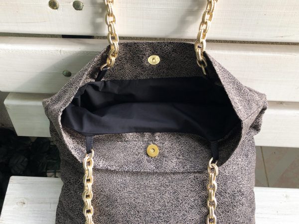 Inside of beige fabric bag on the bench