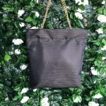 Front of black triangle textured bag