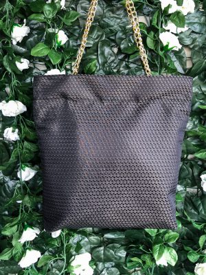 Front of black triangle textured bag