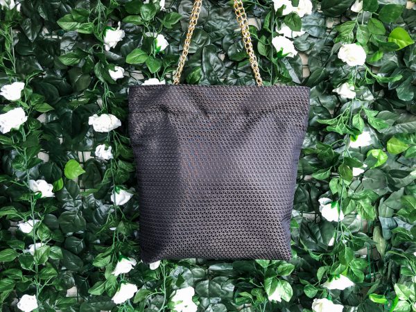 Front of black triangle textured bag