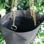 Top of black triangle textured bag