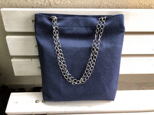 Front of big blue cotton bag on the bench